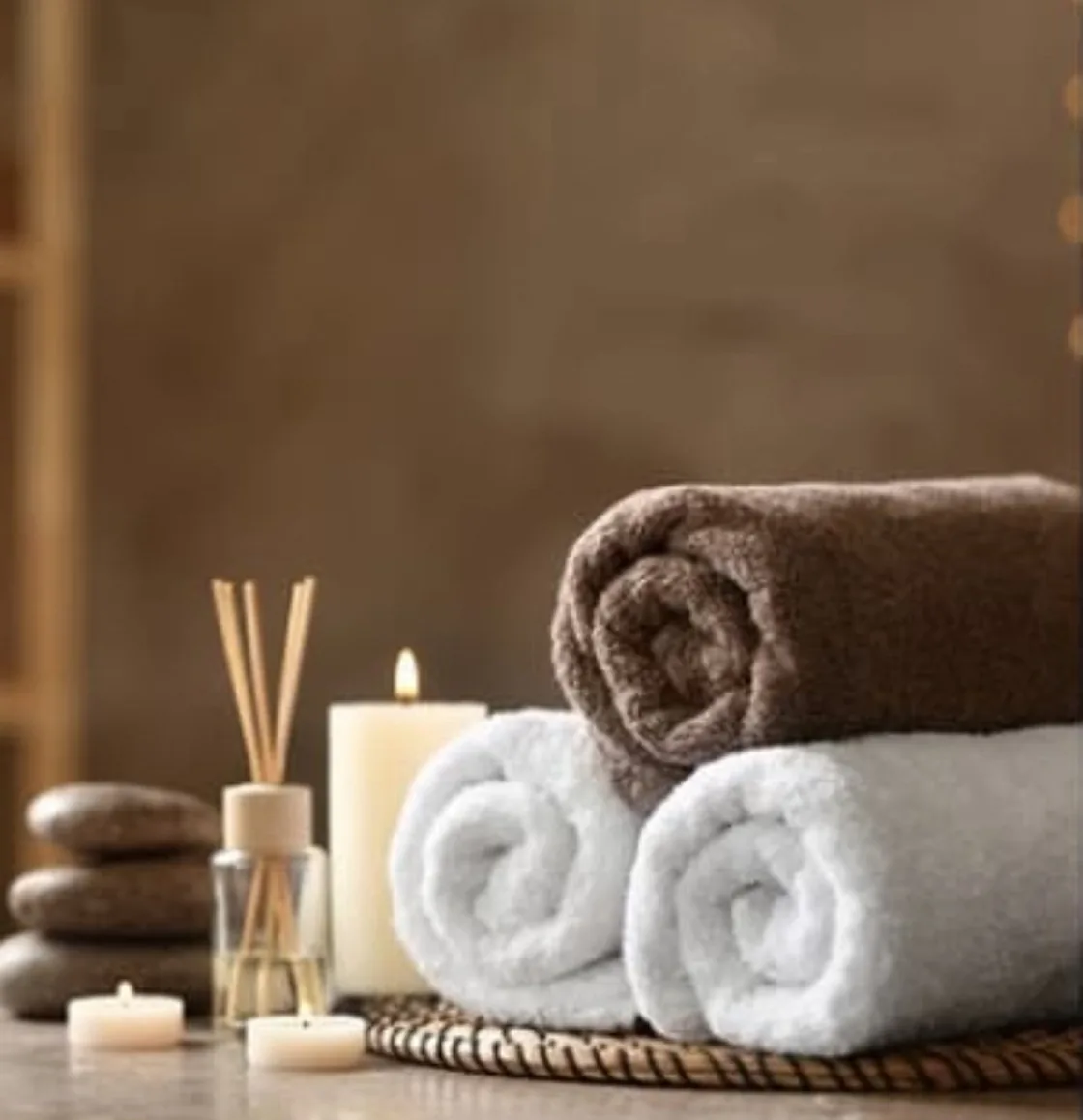 Warm towels, a lit candle and skincare set out in the Clean Skin treatment room